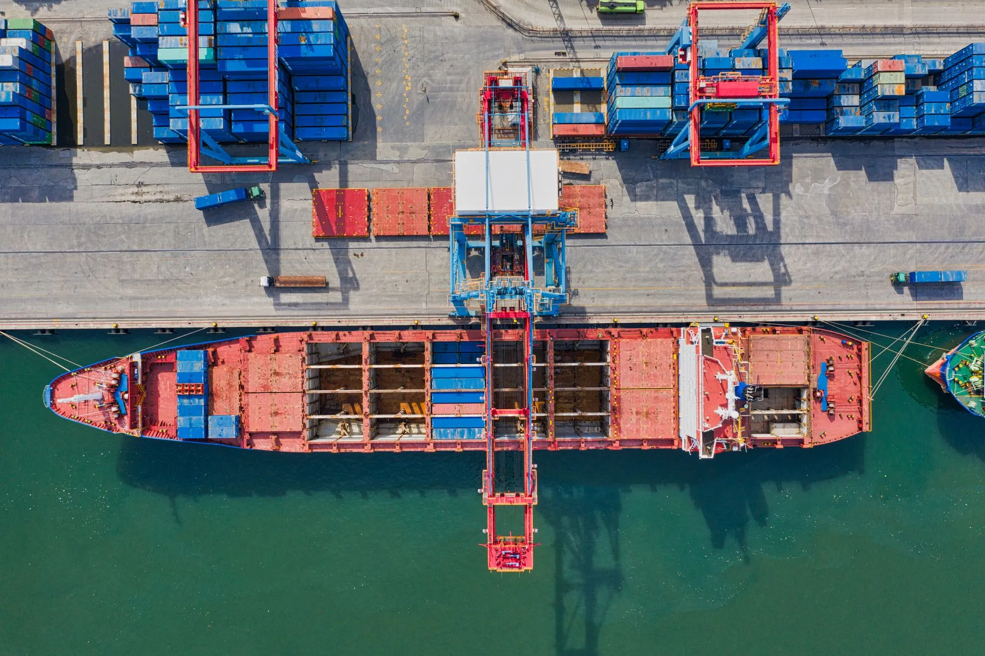 Aerial view of a busy international shipping port at dusk